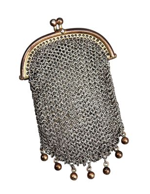 a silver purse with a chain and beads hanging from it
