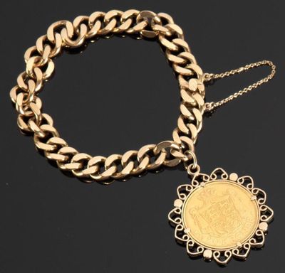 un bracelet en or orné d'une pièce et entouré d'une chaîne