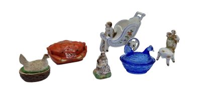 several figurines of different sizes and shapes are displayed on a white surface