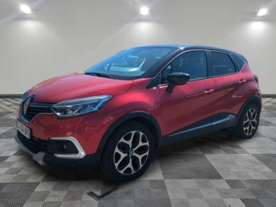 a red renault c - hr suv parked on a checkered floor