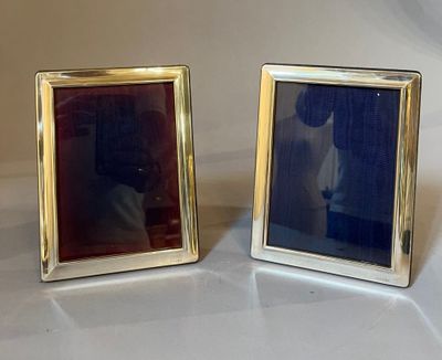pair of silver picture frames with a picture of a man and a woman