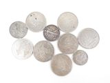 a lot of coins that are on a white surface