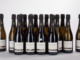 six bottles of wine are lined up in a row on a table