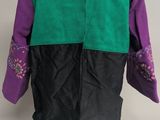 a close up of a mannequin wearing a green and purple jacket