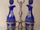 two blue vases sitting on a silver stand