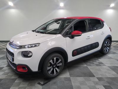 a white and red citrole car parked in a garage