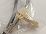 a close up of a tennis racket wrapped in plastic