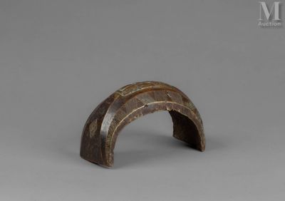 a close up of a wooden object on a gray surface