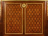 an antique wooden cabinet with gold trimming and ornate carvings