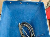 a blue box with a hose in it and a pair of shoes