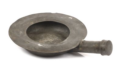 a small metal bowl that is sitting on a white surface