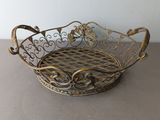 an antique brass basket with a checkered design on the bottom