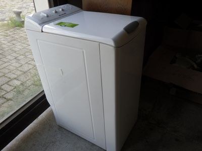 an image of a white washing machine in front of a window
