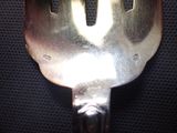 a fork that is sitting on a black cloth