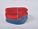 a red and blue hat sitting on top of a white table