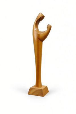 a wooden sculpture of a hand holding a piece of wood