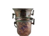 a large metal vase with handles on a white background