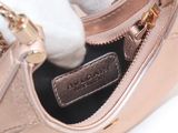 a close up of a pink purse with a gold chain