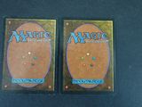 two decks of magic the gathering are shown on a table