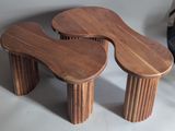 two wooden stools that are sitting on a table