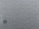 someone is flying a kite in the middle of a snow covered field