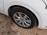 a white car that is parked on the side of the road