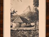 an old picture of a house in a field with a mountain in the background