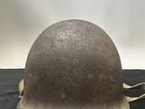 an old helmet is sitting on a black surface