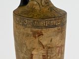 a vase with a painting on it on a stand