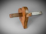 an old wooden hammer with a wooden handle on a gray background