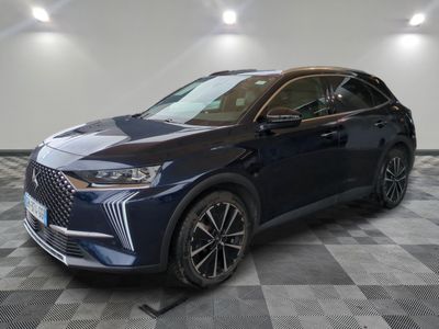 a blue suv parked on a checkered floor in a garage