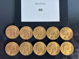 six different types of gold coins sitting on top of a black surface