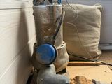 a pipe that is sitting on the floor next to a pillow