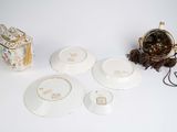 a white table topped with plates and bowls and a purse