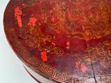 a red table with a gold and red design on it