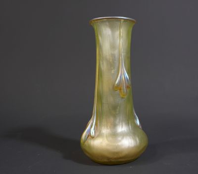 a green glass vase with a gold design on it