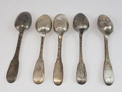 six spoons are lined up in a row on a white surface