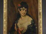 une peinture à l'huile représentant une femme tenant un éventail, posée sur un chevalet en bois