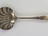 a spoon that is sitting on a white surface