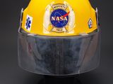 yellow fireman ' s helmet with nasa emblem on it
