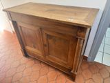 a small wooden cabinet with a door on top of it