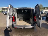 a white van with its doors open in a parking lot
