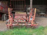 a tractor that is parked in front of a building