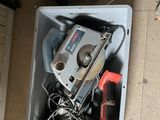 an overhead view of a box with tools in it on the floor