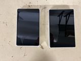 two cell phones sitting next to each other on a table