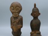 pair of old wooden figurines of a man and a woman