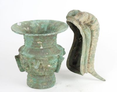two green vases sitting next to each other on a white surface