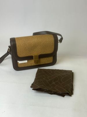 brown and black purse and wallet on white surface
