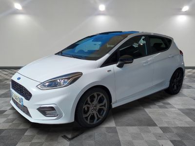 a white ford fiesta parked on a checkered floor in a garage