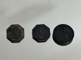 four different types of coins on a white surface